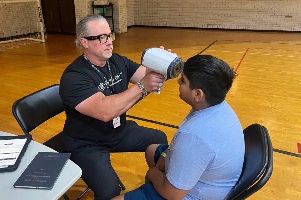 Student receives eye exam