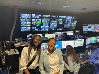 2 CIS of Chicago students pose in the control center of a TV studio during their visit to Fox32 to discuss violence reduction ideas.